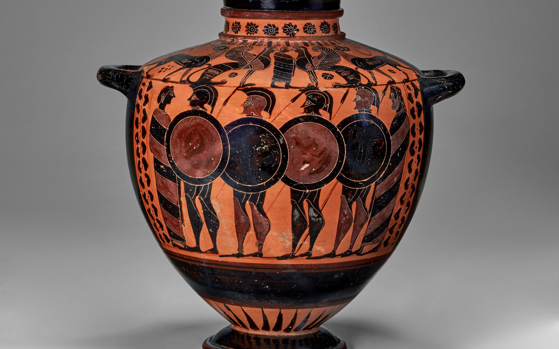 Ancient Greek hydria depicting warriors, in black-figure pottery style, with detailed figures and patterns around the vessel.