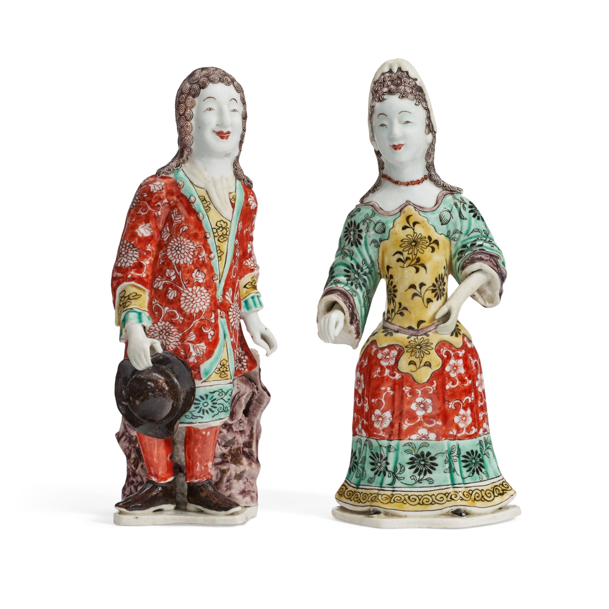 Two colorful porcelain figurines dressed in traditional, intricate costumes.