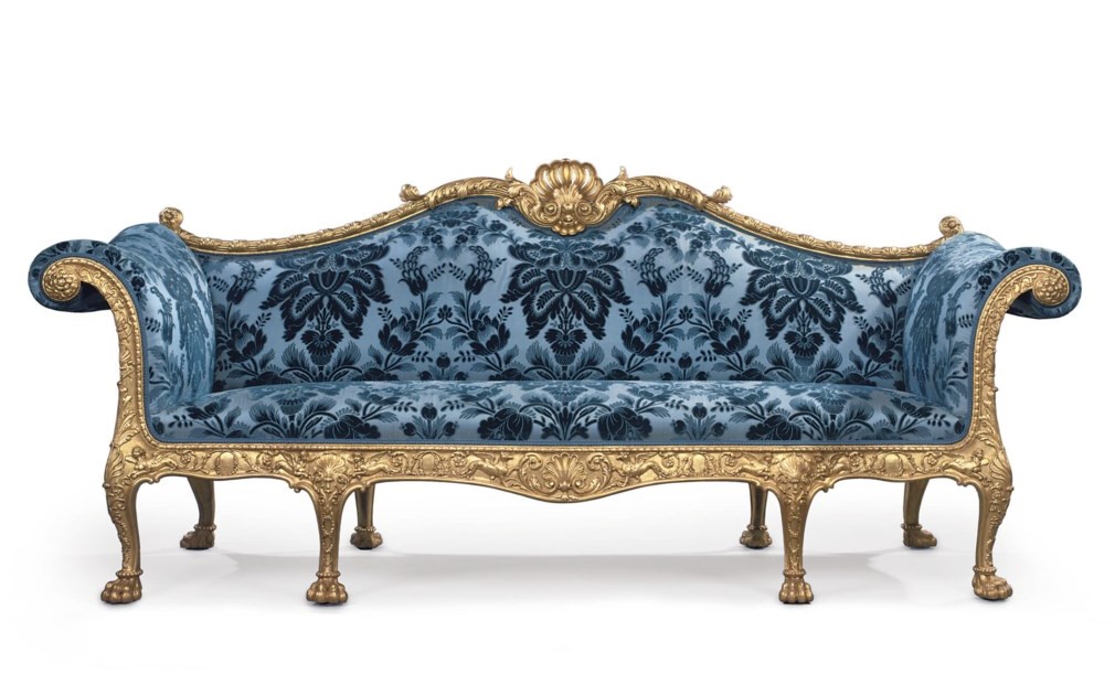 Elegant antique sofa with ornate golden frame and blue upholstered fabric featuring intricate patterns.