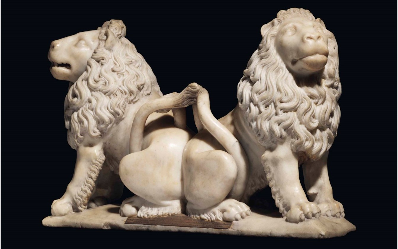 A CARVED MARBLE GROUP OF TWO ADDORSED LIONS