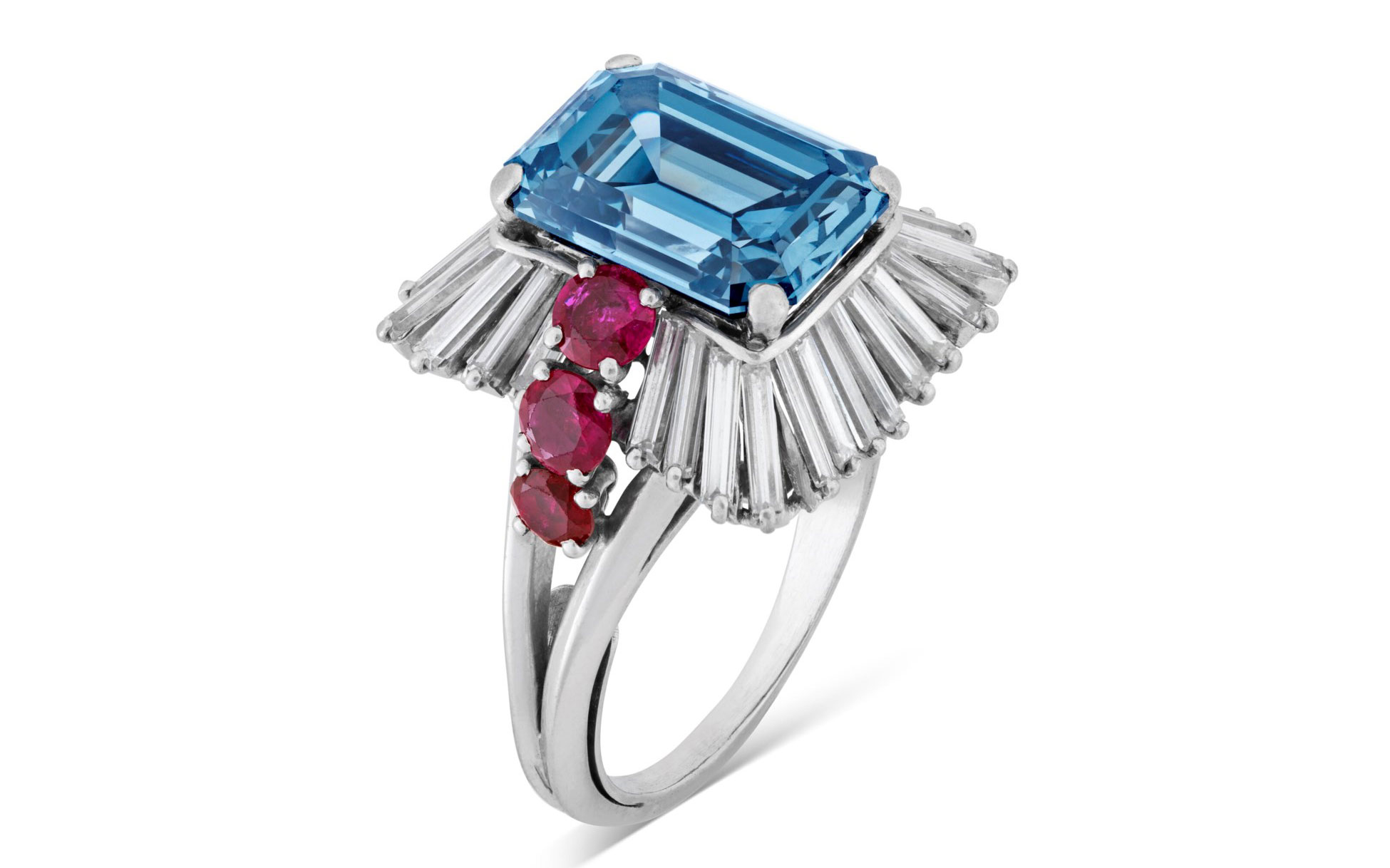 A luxurious ring featuring a large blue rectangular gemstone surrounded by pink gems and flanked by rows of clear baguette diamonds.