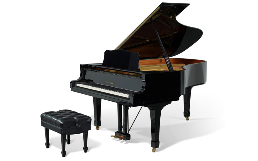 A black grand piano with an open lid and a matching bench, isolated on a white background.
