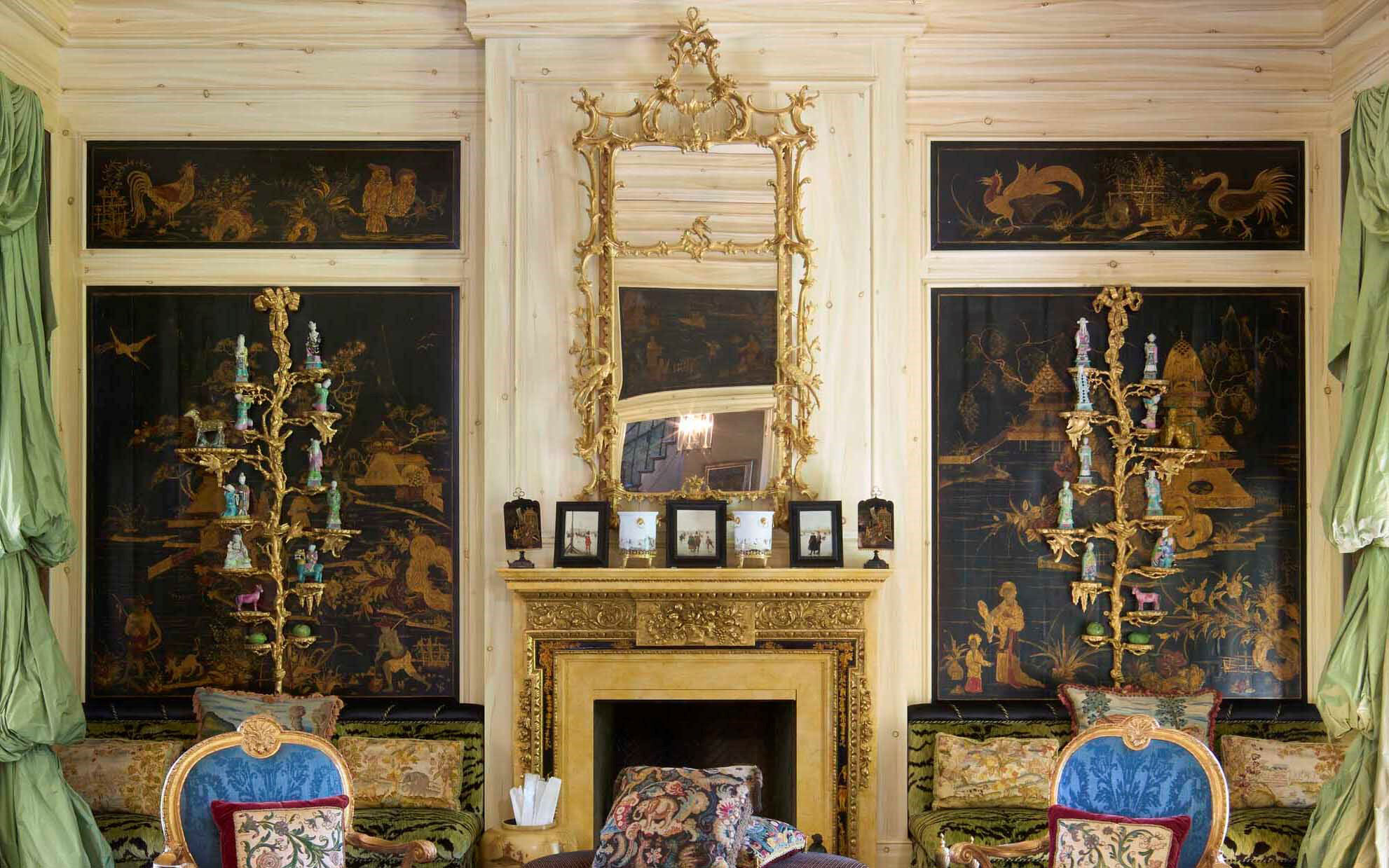 An ornate room featuring gilded elements, exotic panels, and plush upholstered furniture.