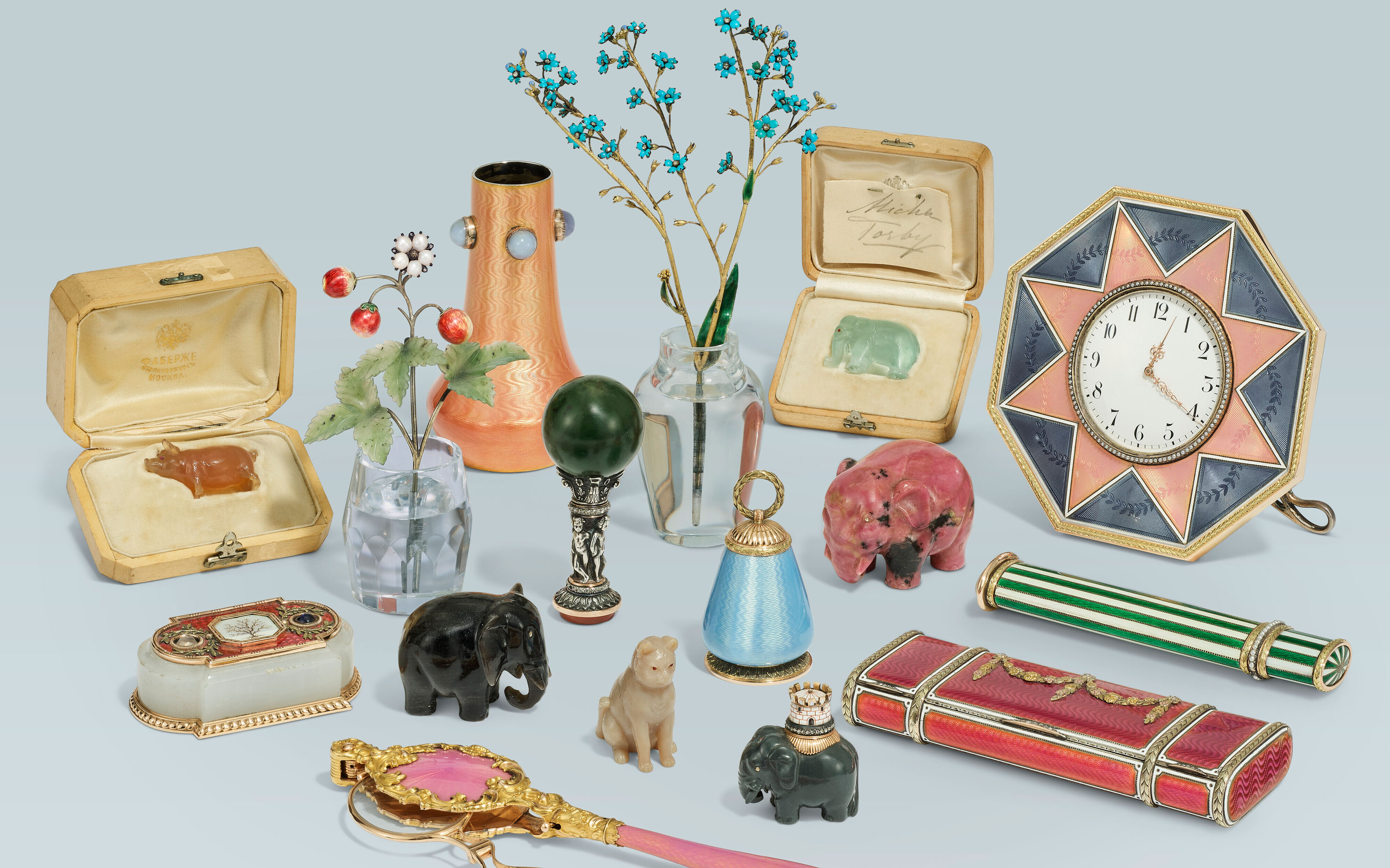 A collection of eclectic vintage objects including jewelry boxes, animal figurines, a clock, and decorative items.