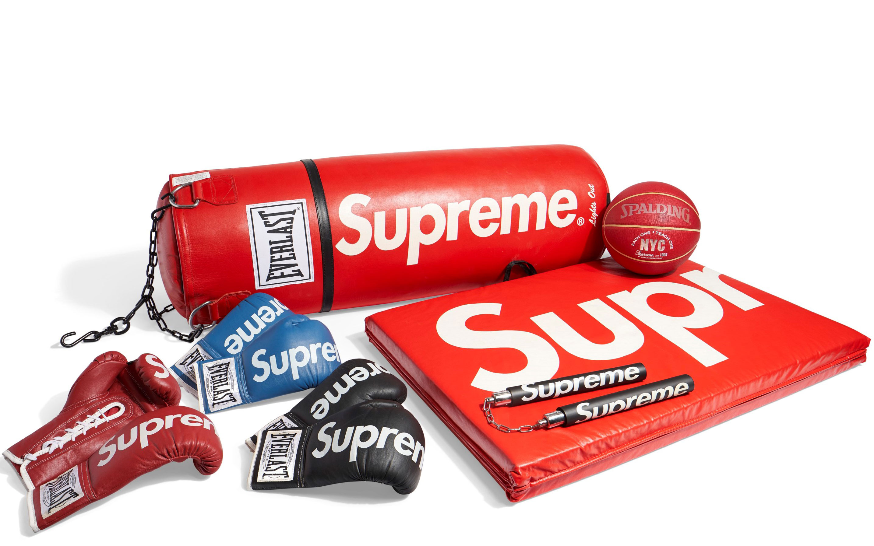 A collection of sports equipment branded with "Supreme" including boxing gloves, a punching bag, a basketball, and a mat.