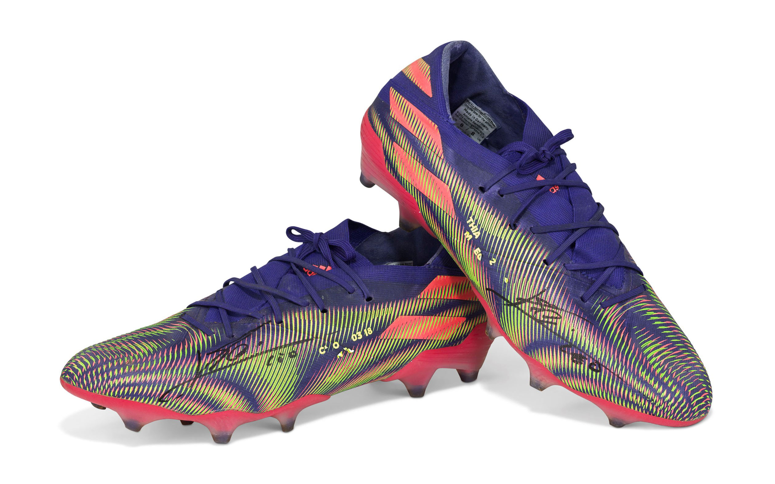 A pair of vibrant, multi-colored sports cleats on a white background.