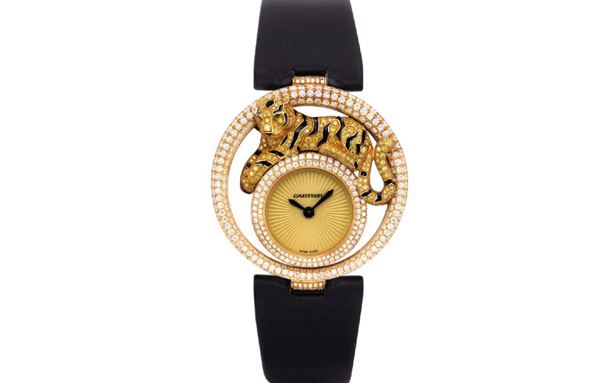 A luxurious gold Cartier watch with a black strap, featuring a panther design encrusted with diamonds around the bezel.