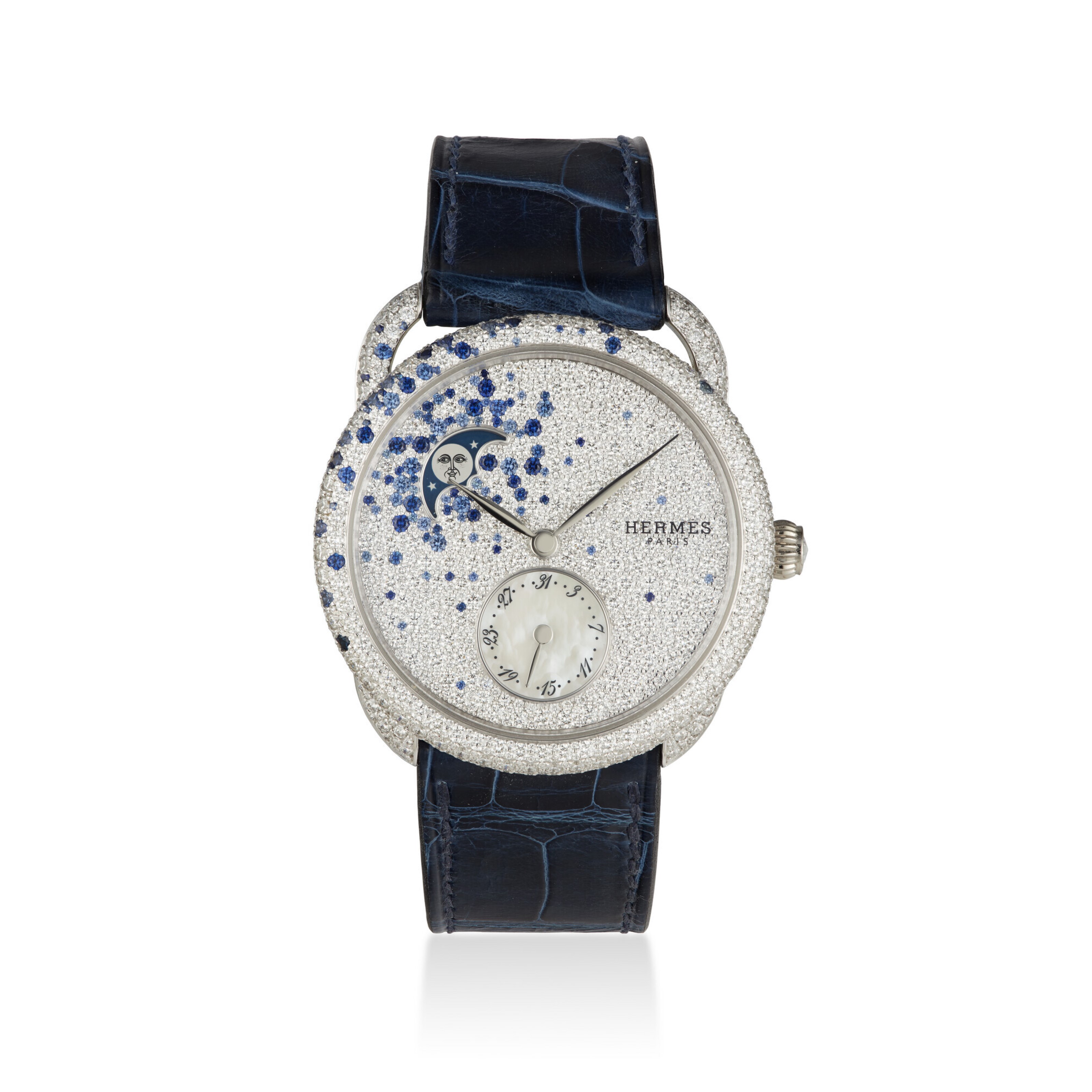 A luxury Hermès watch with a diamond-studded face, blue accents, and a dark blue leather strap.