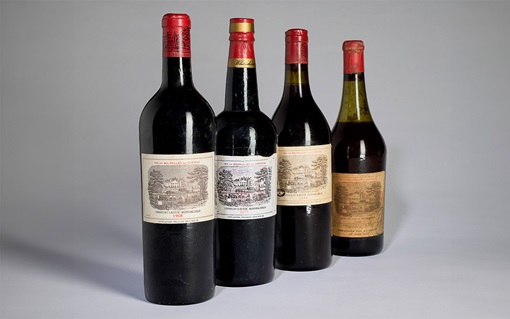 Four bottles of Château Lafite Rothschild wine are displayed in a row against a plain background.