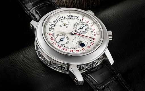 A luxurious Patek Philippe wristwatch with intricate engravings and multiple dials on the face.