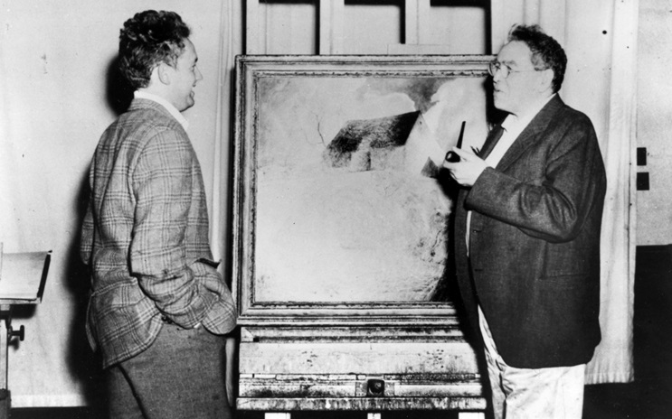 N.C. Wyeth (right) and his son Andrew Wyeth are examining a large, framed abstract painting in N.C. Wyeth’s studio.