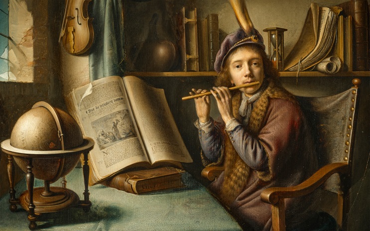 A person wearing a fur-trimmed robe plays a flute in a study filled with books, a globe, an hourglass, and a violin.