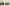 A lineup of seven prestigious champagne bottles on a neutral background.