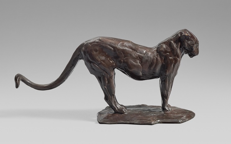 This is a bronze sculpture of a panther in a stretched, stalking position, exhibiting detailed muscle definition.