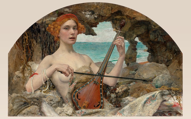A woman with red hair plays a stringed instrument by the sea in a rocky setting.