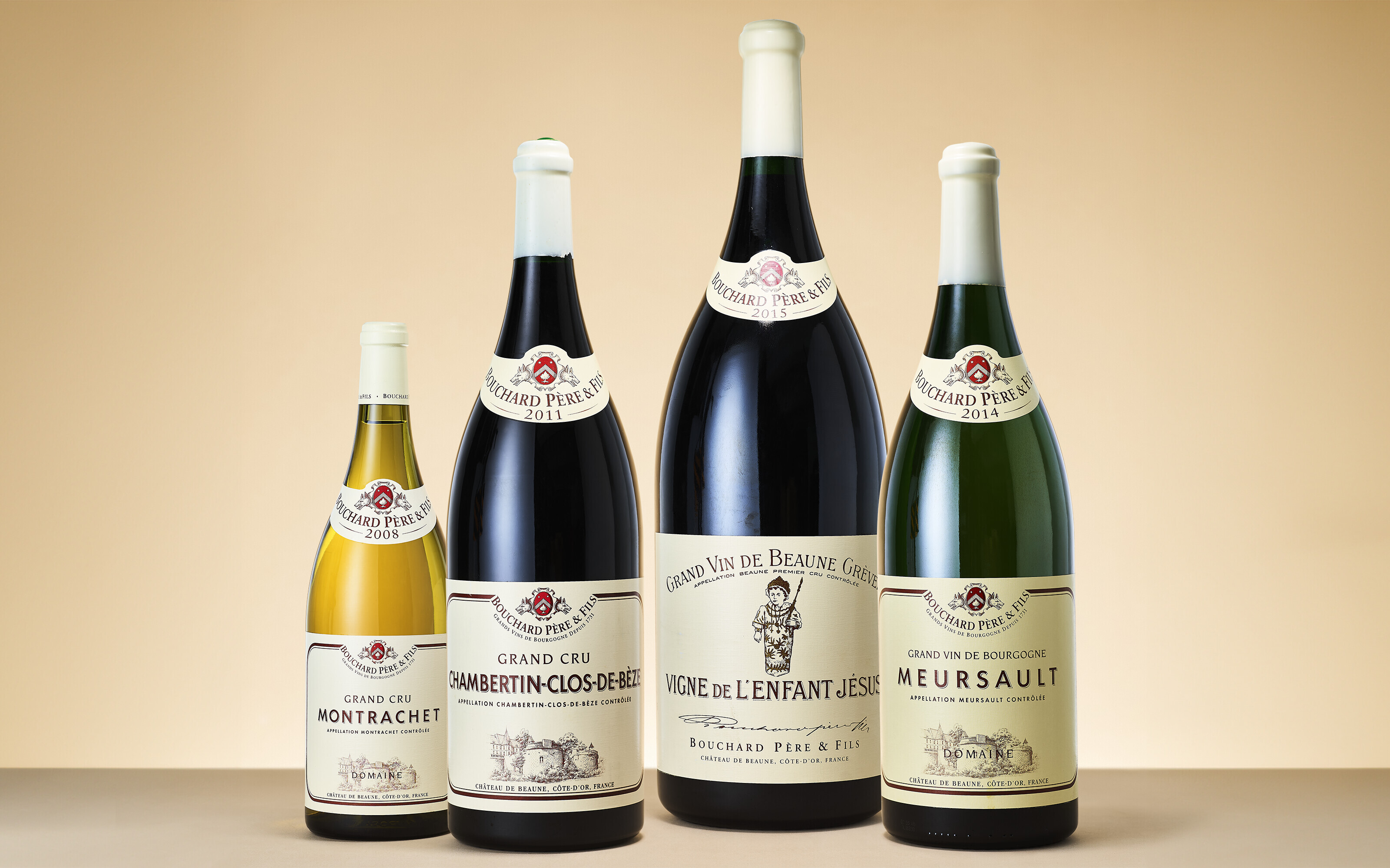 Four bottles of Bouchard Père & Fils wine are displayed against a beige background.