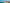 Panoramic view of a modern coastal city skyline along a crowded beach under a clear blue sky.