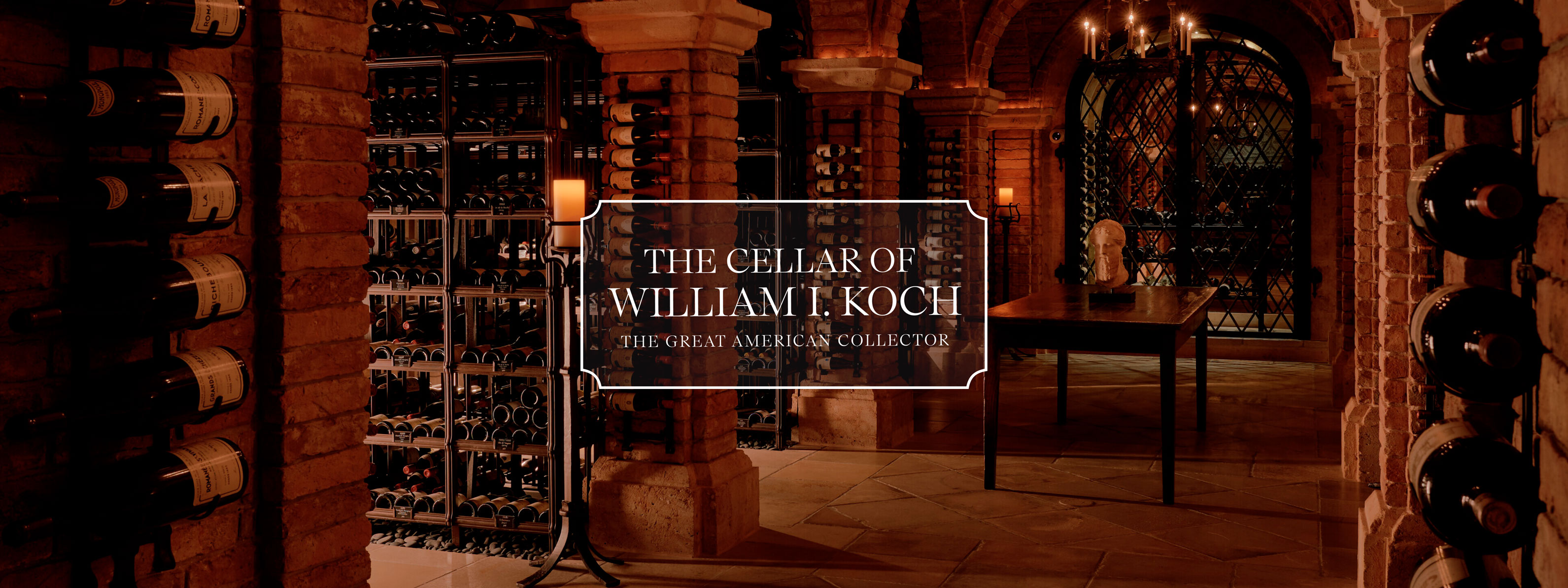 A sophisticated wine cellar with numerous bottles, ornate gates, and a classic brick interior, marked as William I. Koch's collection.