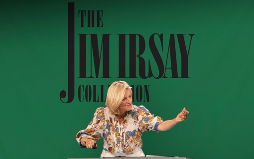 A person wearing a floral shirt stands in front of a green backdrop with "The Jim Irsay Collection" text.