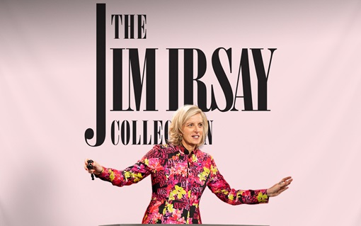 A person in a colorful floral suit stands in front of "The Jim Irsay Collection" sign.