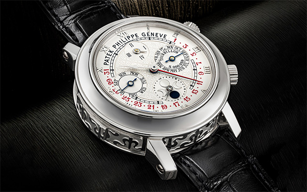 A luxury Patek Philippe wristwatch with a complex, detailed dial and black leather strap.
