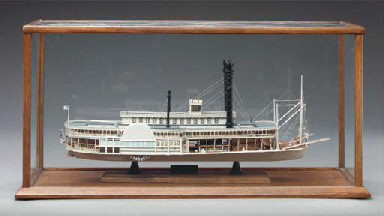 A CARVED POLYCHROME DECORATED WOODEN MODEL OF THE PADDLE 