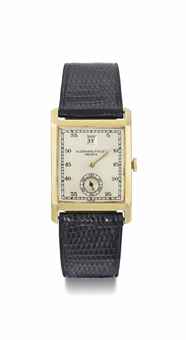 Audemars Piguet. A rare 18K gold rectangular Jump Hour wristwatch with hinged back case
