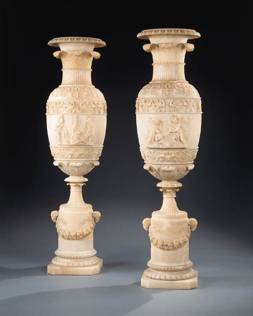 A pair of Italian carved alabaster vases on stands , IN THE NEO