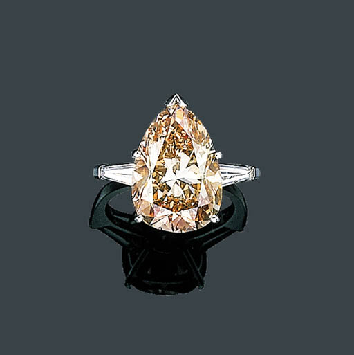 A FANCY BROWN-PINK AND NEAR COLORLESS DIAMOND RING, RUSER