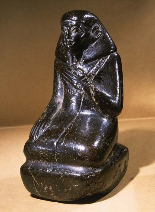 AN EGYPTIAN BASALT FIGURE OF A SEATED NOBLEMAN , MIDDLE KINGDOM
