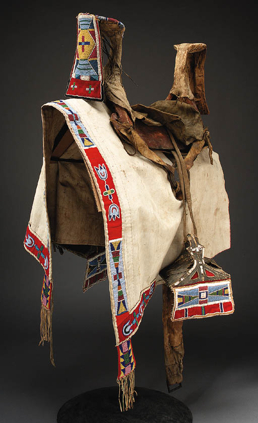 A CROW BEADED HIDE SADDLE, HEADSTALL, AND SADDLE BLANKET 