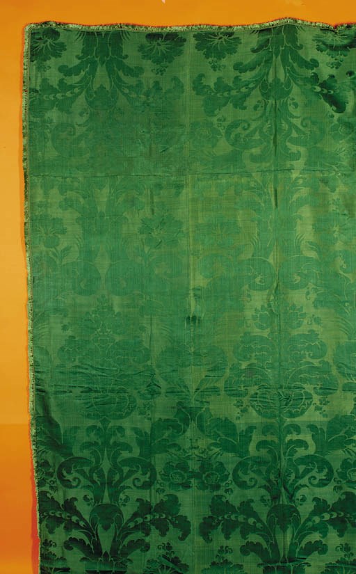 A joined coverlet of green silk damask, woven with a sweeping pattern