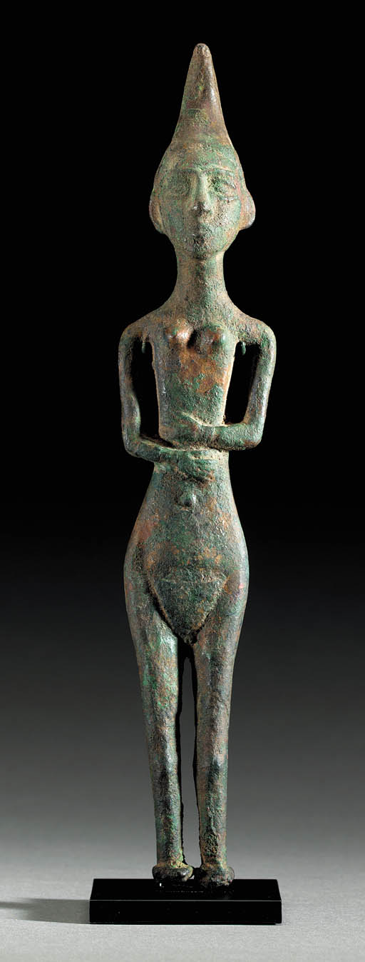 A CANAANITE BRONZE FEMALE DEITY , CIRCA FIRST HALF OF THE SECOND