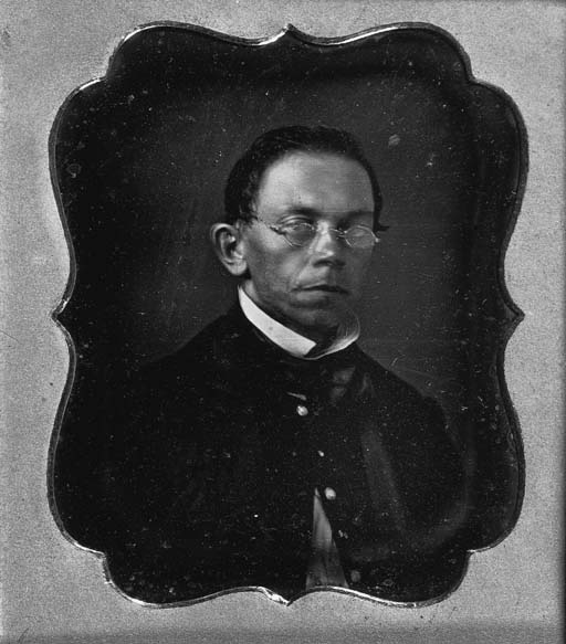 "Minister wearing spectacles" 
