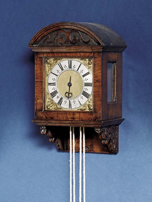 A Charles II walnut striking hooded wall clock