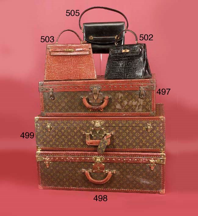 A Louis Vuitton suitcase, covered in LV monogram canvas, bound in