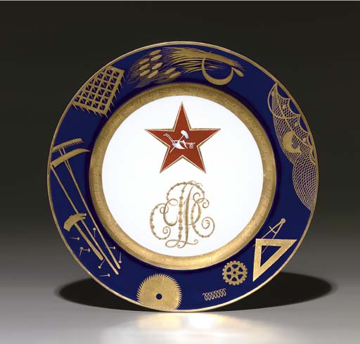A Soviet propaganda porcelain plate, by the Imperial Porcelain Factory, period of Nicholas II, 1897, with later blue overglaze State Porcelain Factory jubilee mark of cog, V, hammer and sickle, dated 1922, numbered 215/15. After a design by Mikhail Adamovich. Diameter&nbsp;9&frac12; in (24.3 cm). Sold for &pound;50,400 on 30 November 2005 at Christie&rsquo;s in London