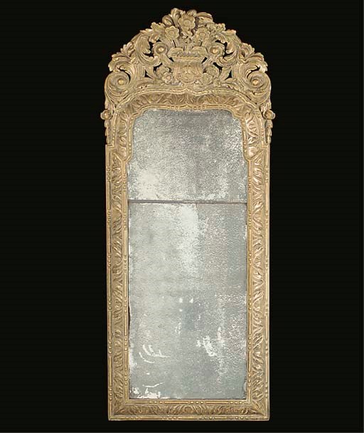 A CARVED SILVERED MIRROR
