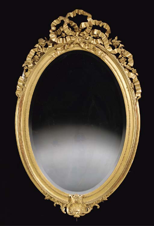 A VICTORIAN OVAL GILT WALL MIRROR WITH RIBBON CRESTING, , SECOND HALF