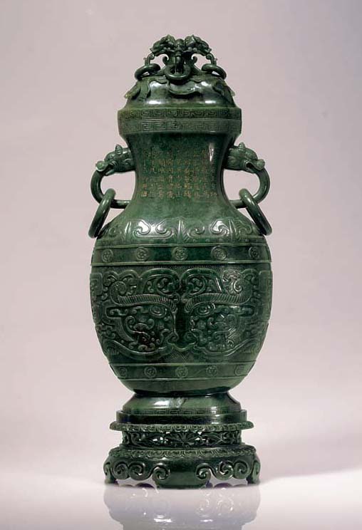 AN IMPORTANT MASSIVE SPINACHGREEN JADE VASE, COVER AND STAND Christie's