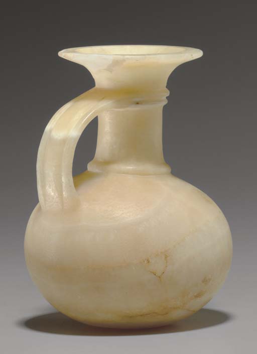 AN EGYPTIAN ALABASTER JUG