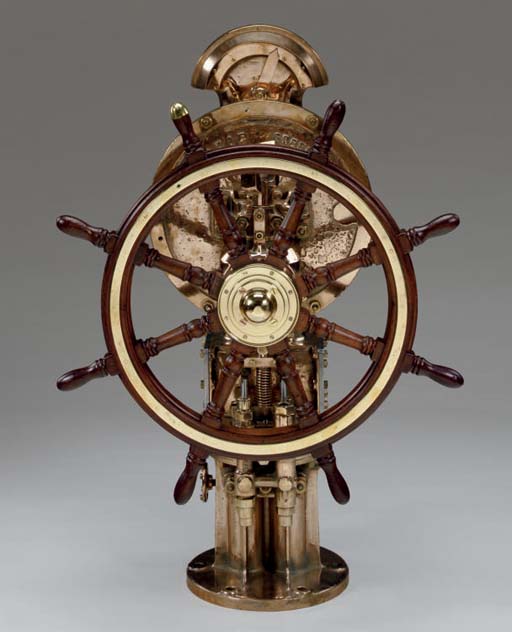 A 20th century eight spoke ship's wheel with bronze base , JOHN