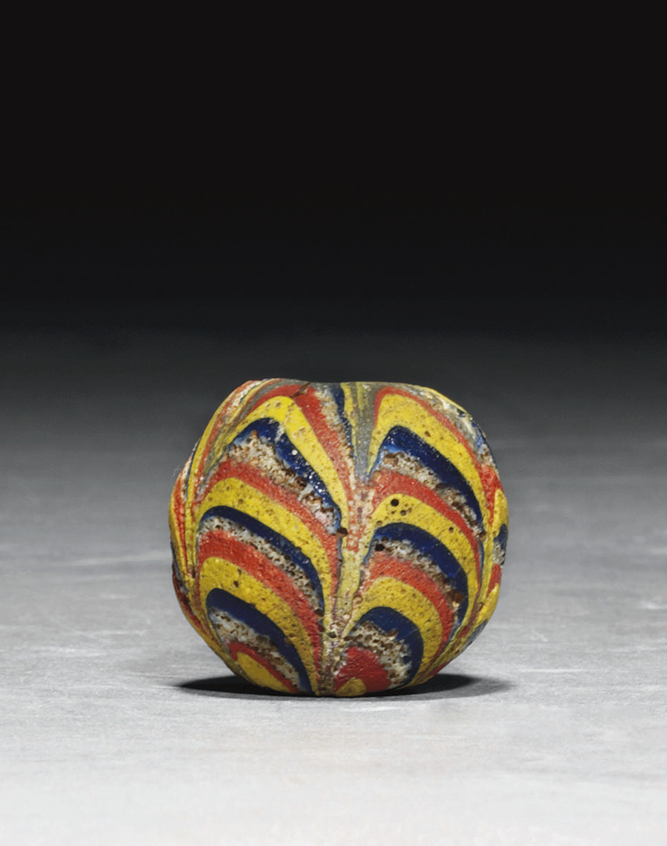 AN EARLY ISLAMIC LARGE MARVERED GLASS BEAD , SYRIA OR EGYPT, 9TH