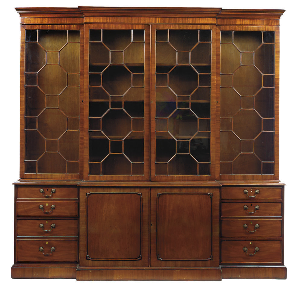 A MAHOGANY BREAKFRONT LIBRARY BOOKCASE , BY ARTHUR BRETT & SONS