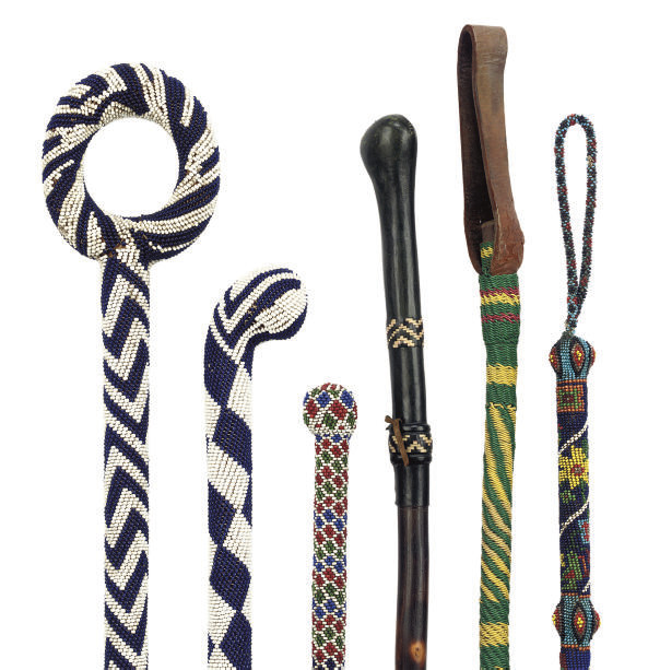 A COLLECTION OF FOUR SOUTH AFRICAN GLASSBEAD DECORATED WALKING STICKS