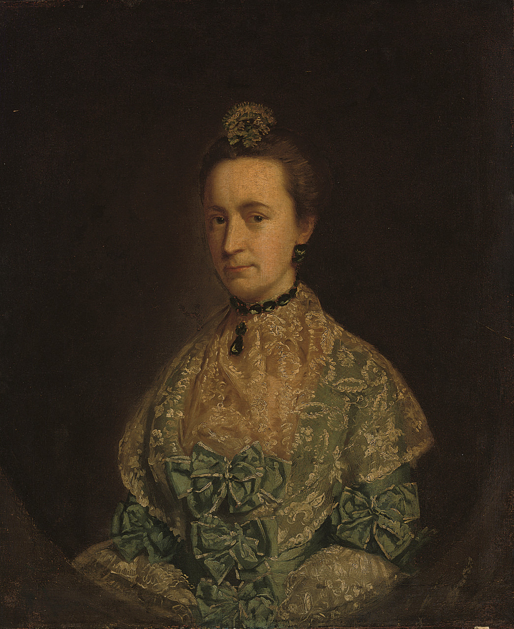 Portrait of a lady, traditionally identified as Mrs John Echlin [?], née Henry, half-length, in a blue silk dress with a lace shawl and a headdress, in a feigned oval
