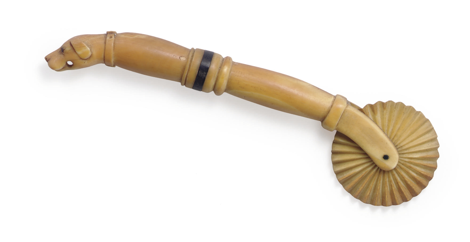 AN IVORY AND BALEEN SCRIMSHAW 'HOUND HEAD' JAGGING WHEEL , NANTUCKET