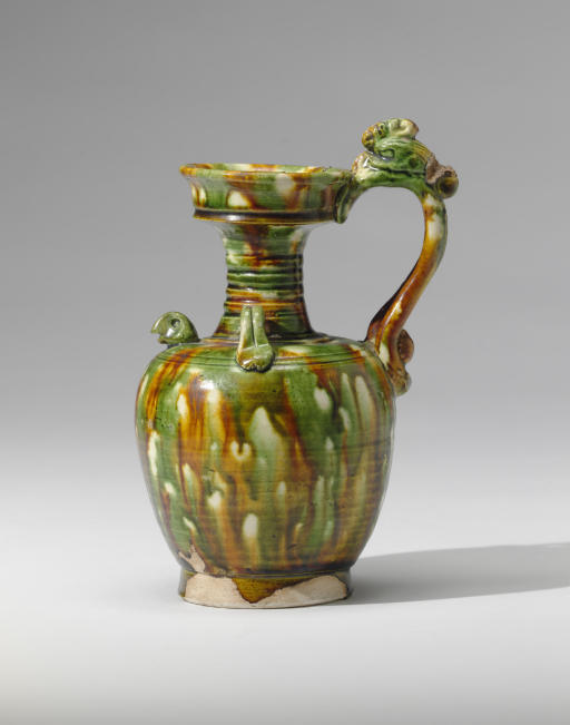A RARE SANCAIGLAZED POTTERY PHOENIXHANDLED EWER , TANG DYNASTY (618