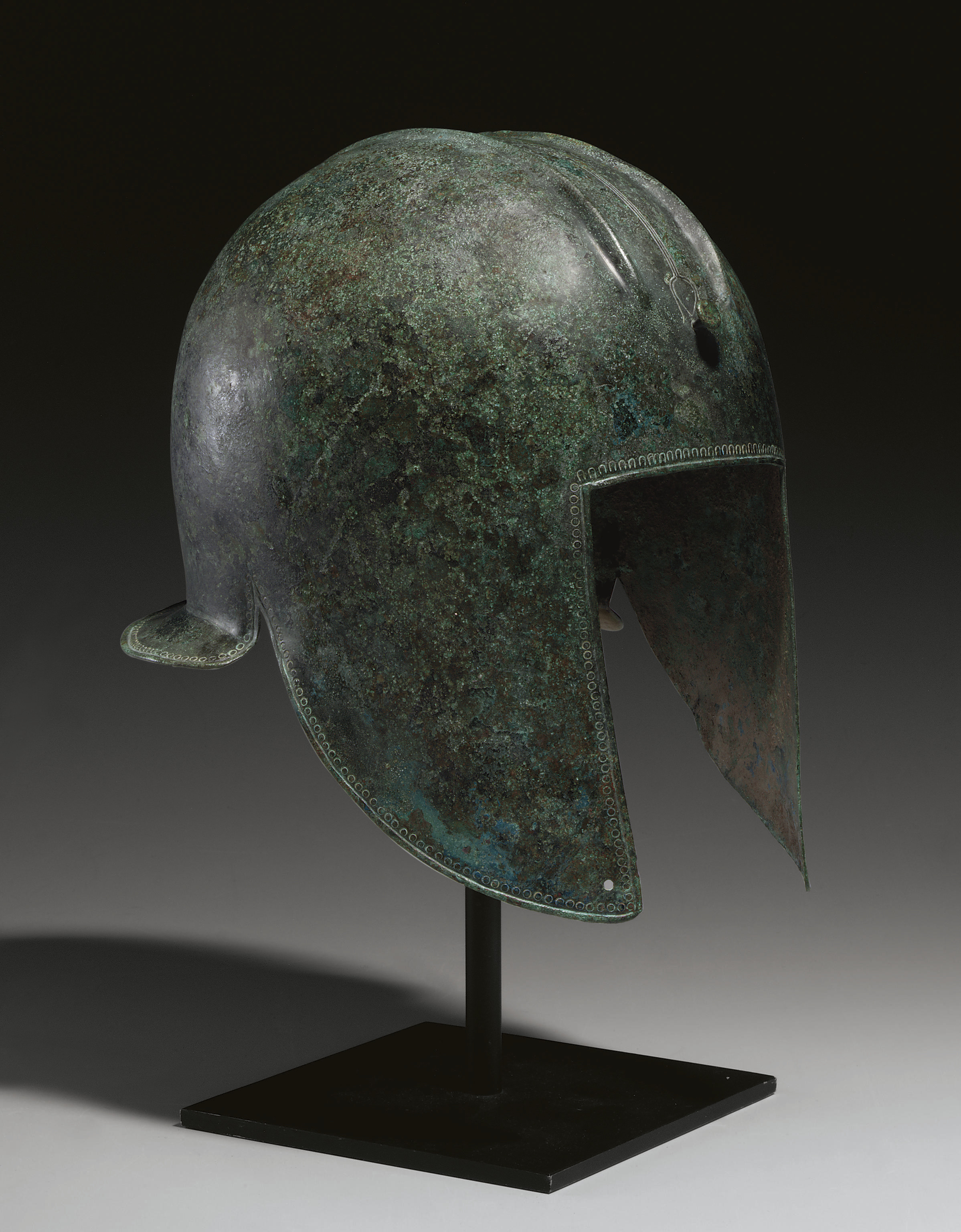 A GREEK BRONZE HELMET OF ILLYRIAN TYPE , ARCHAIC PERIOD, CIRCA 6TH
