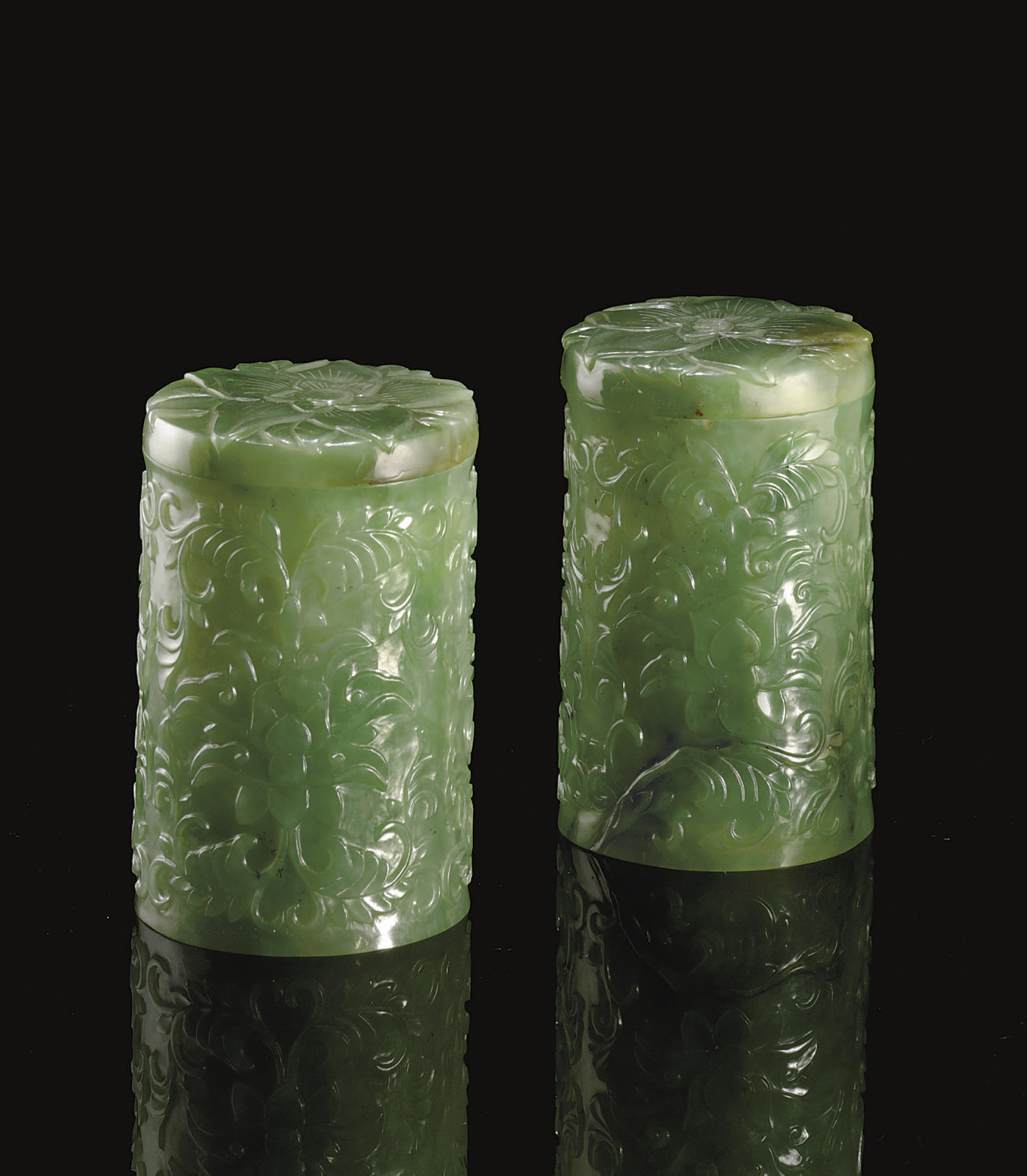 A PAIR OF SMALL GREEN JADEITE CYLINDRICAL CONTAINERS AND COVERS